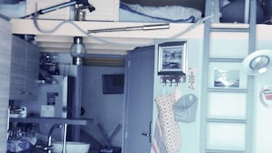 A compact kitchen with a sink, a stove, and a microwave. There is a door with a towel hanging on it. - Unique panorama with the best view of Cassis (Cassis)
