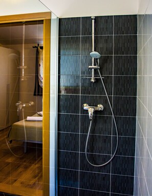 A modern bathroom with a shower, a toilet, and a glass-enclosed shower area.