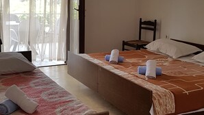 A hotel room with two beds, a chair, and a window with sheer curtains. - House Fani (Zastrazisce)