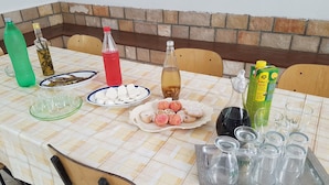 A table set with various food items, drinks, and glassware, indicating a meal setup. - House Fani (Zastrazisce)