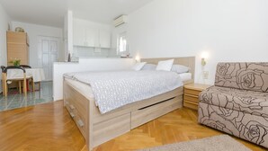 A bedroom with a bed, a sofa, a desk, and a chair. - Apartments Vlasta (Tribunj)