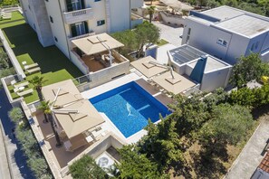 A rooftop swimming pool with a clear view of the surrounding buildings and greenery. - Apartments Dyana (Novalja)
