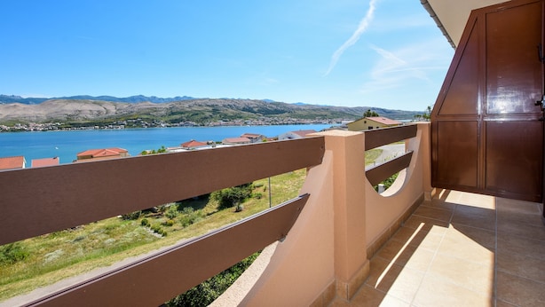 Ein Balkon mit Blick auf einen See und Berge.