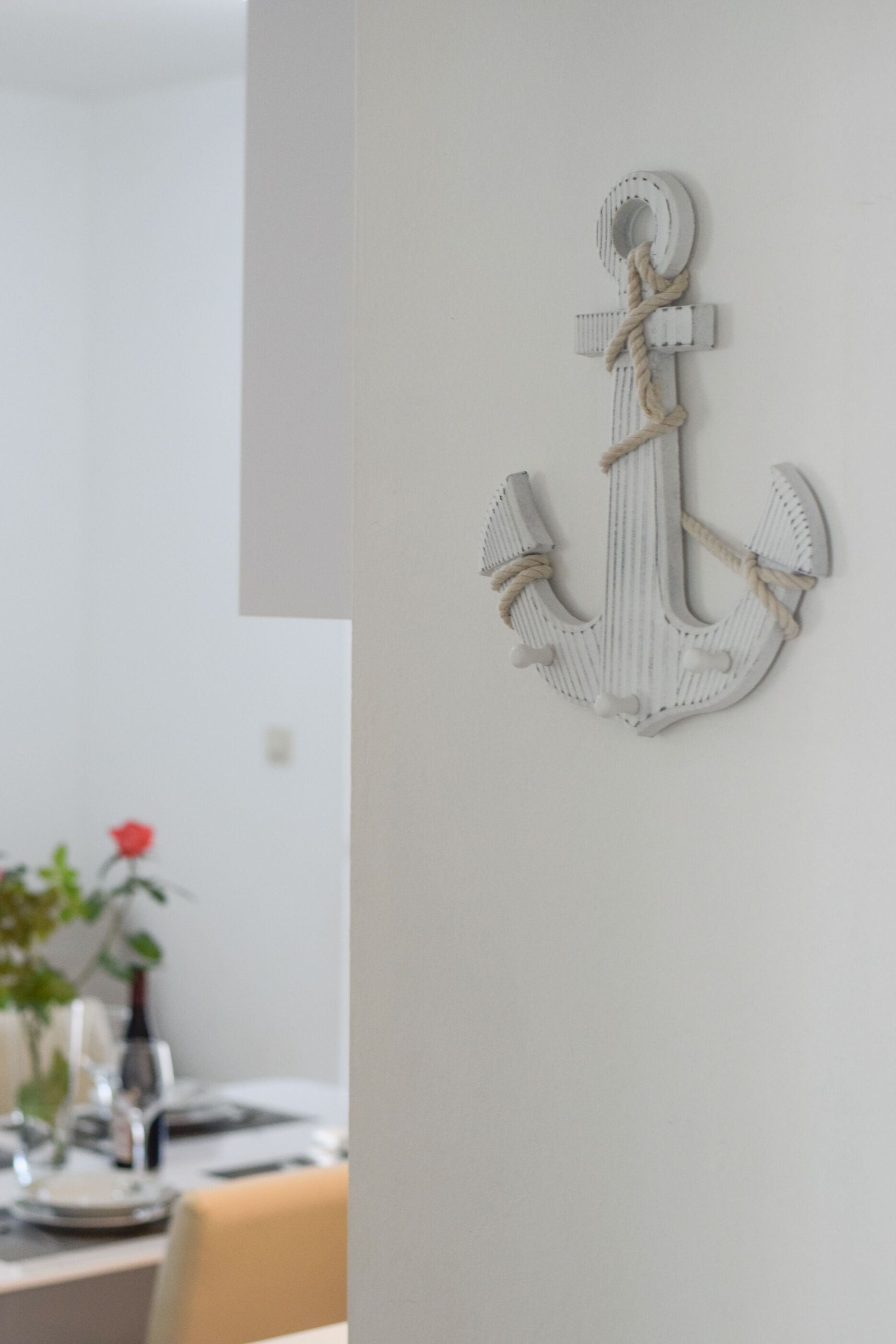 A white anchor decoration on a wall.