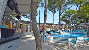 Ein Poolbereich mit Liegestühlen und einer Bühne.
