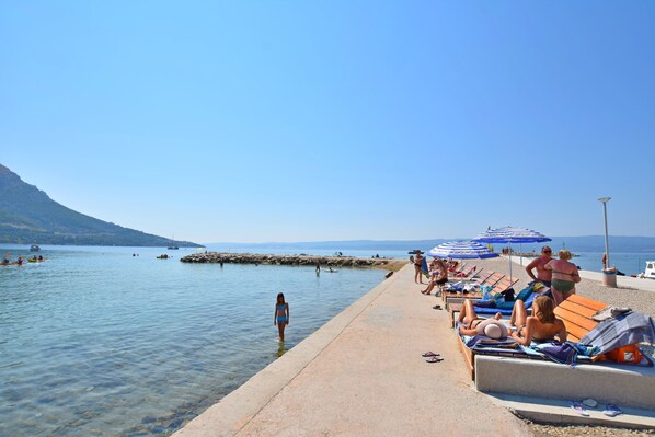 Enjoy a serene beachside retreat with access to calm waters and stunning mountain views.