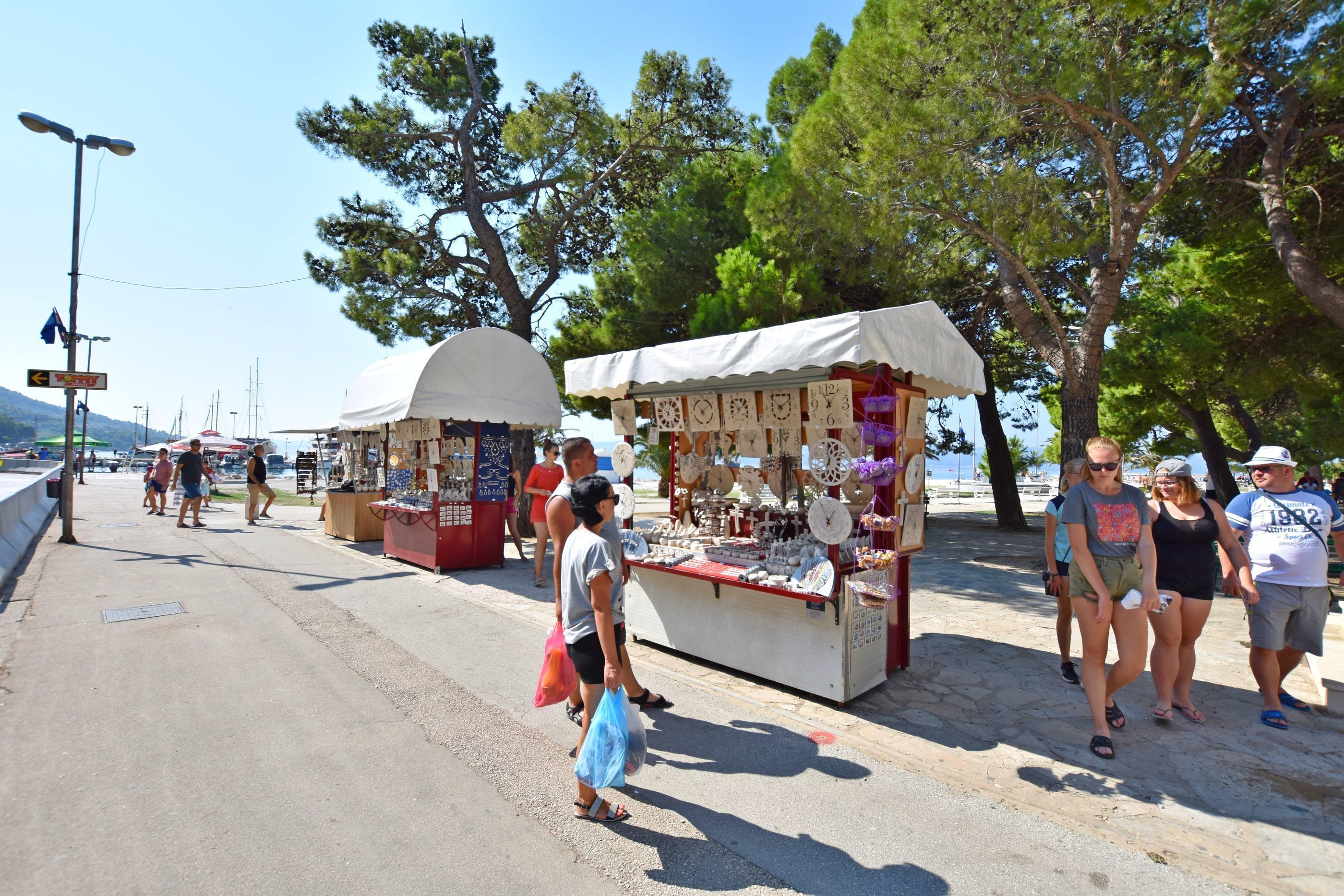 A street market with stalls selling various items.