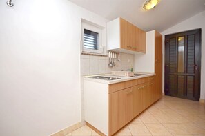Apartment (A2) | Private kitchen | Fridge, stovetop, electric kettle, cookware/dishes/utensils - Apartments Ivan by the sea (Vodice)