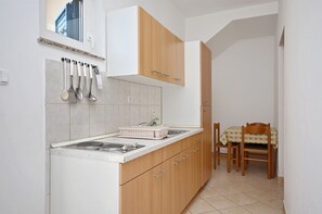 Apartment (A3) | Private kitchen | Fridge, stovetop, electric kettle, cookware/dishes/utensils - Apartments Ivan by the sea (Vodice)