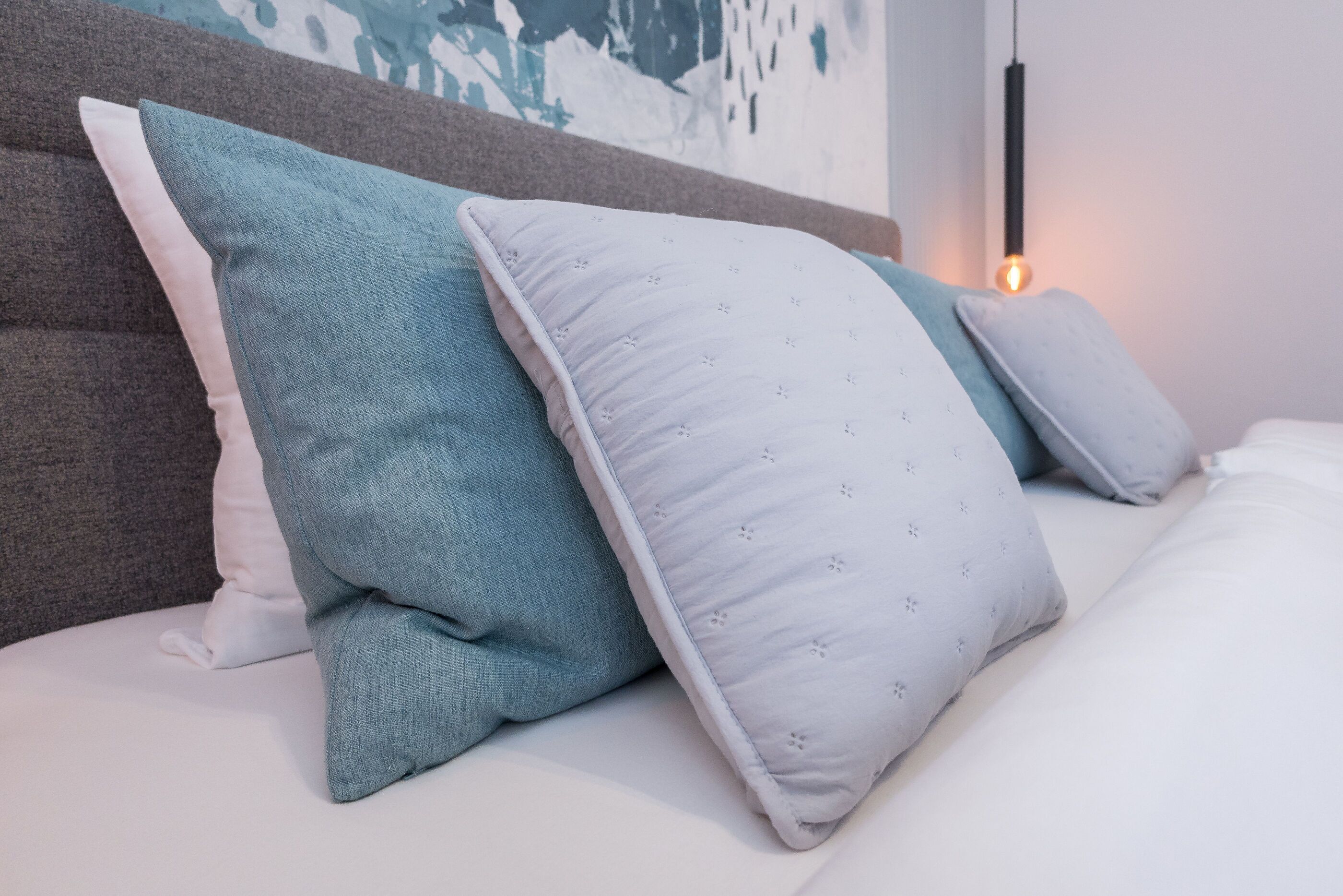 A bed with pillows and a headboard.