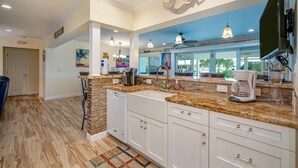 A modern kitchen with a granite countertop, white cabinetry, and a built-in dishwasher. - AUGUST Opening, Fishermen, Couples, Families, Pool, Cabana Club (Key Colony Beach)