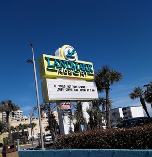 A Landmark Resort sign with amenities listed, including pools, hot tubs, and a lobby coffee bar. - Lee's Myrtle Beach Condo (Myrtle Beach)