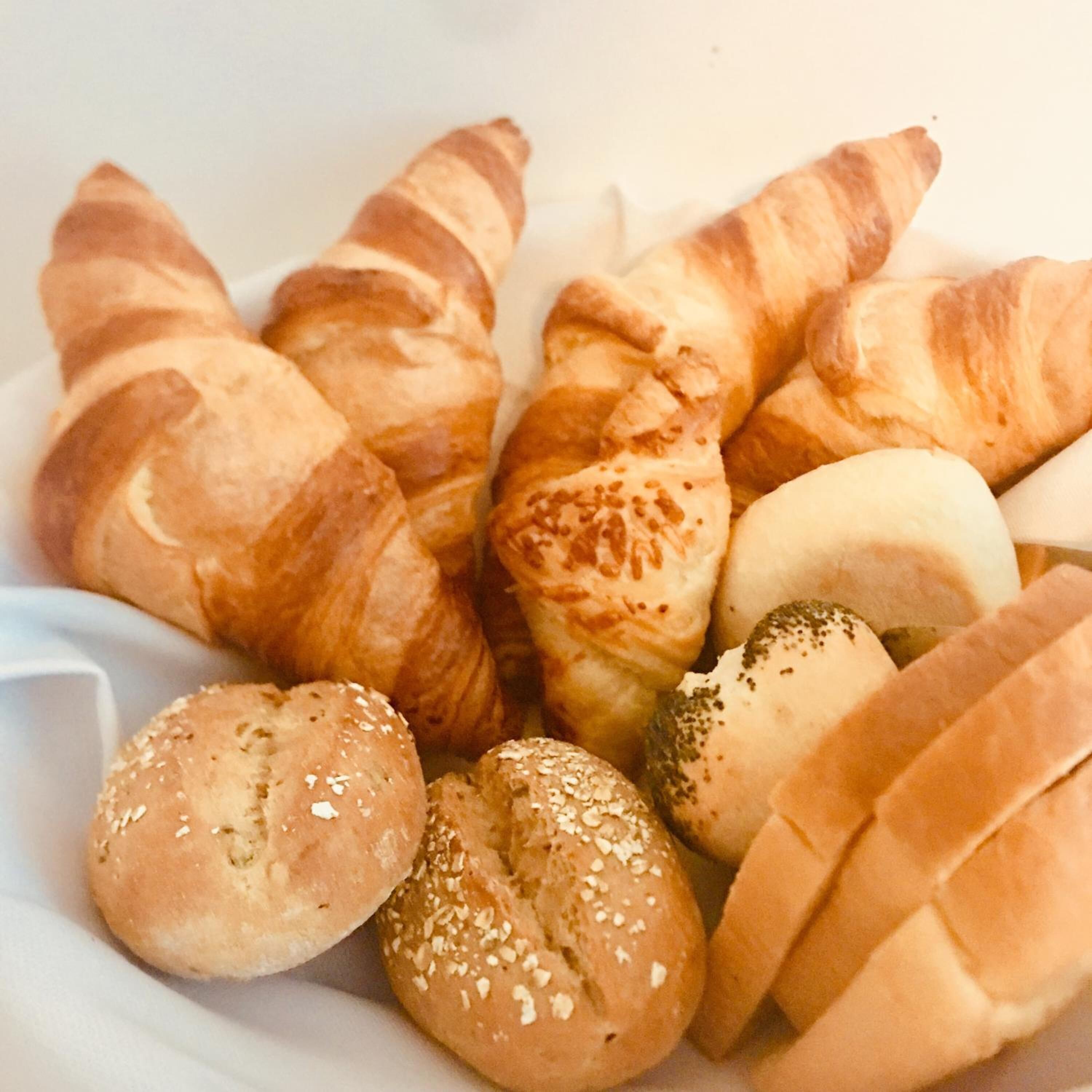 A variety of baked goods including croissants, rolls, and bread rolls.