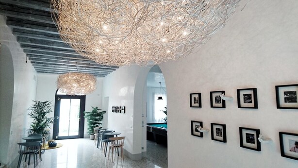 Un interior moderno con comedor, mesa de billar y cuadros en la pared.