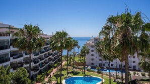 Ein Resort mit Pool, Palmen und Meerblick.