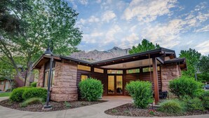 A modern house with a stone facade, large windows, and a covered porch. - LaFave-Luxury Home at Zion: West Temple (Springdale)