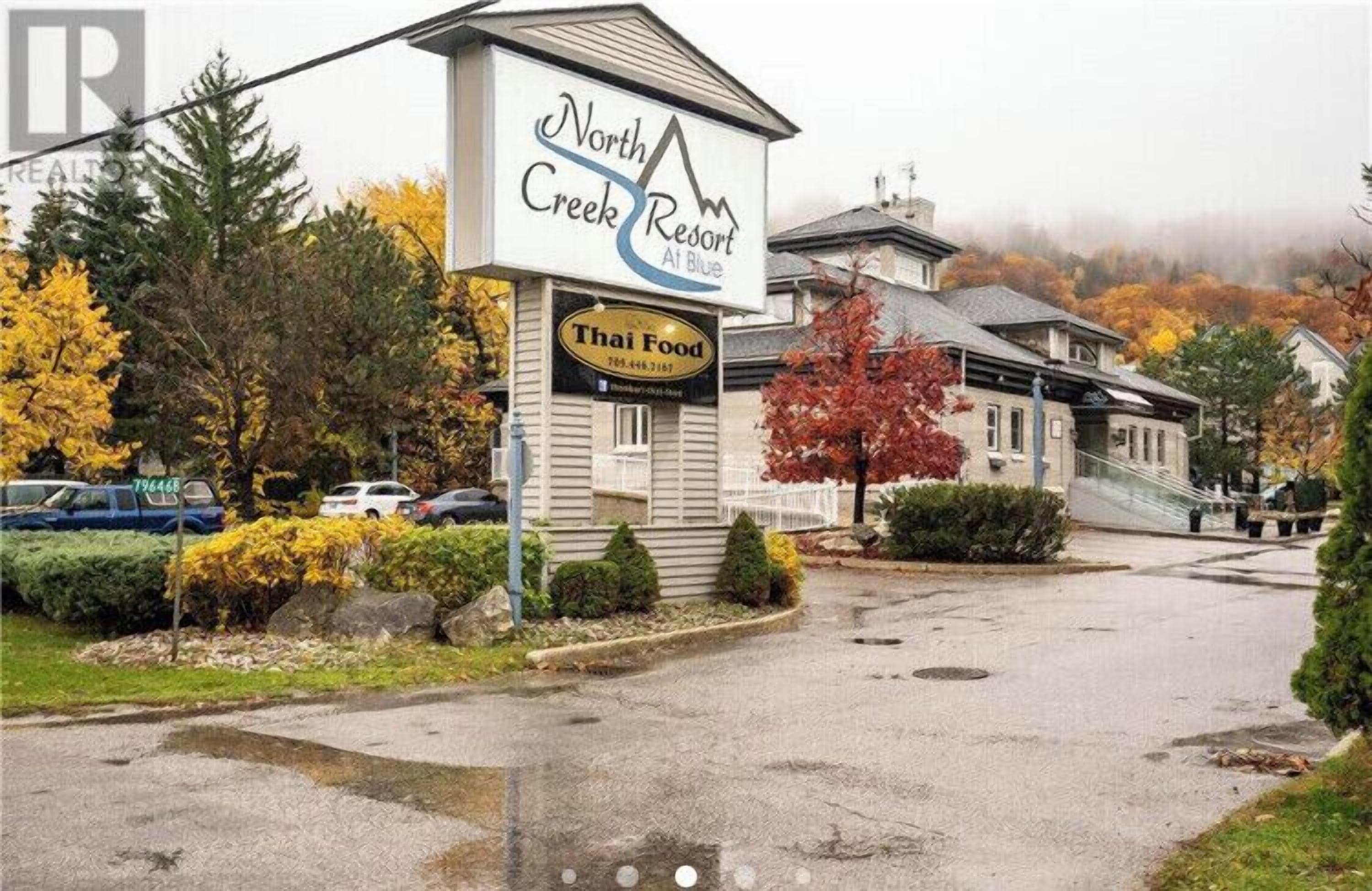 A North Creek Resort building with a Thai Food sign.