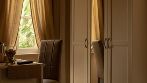 A room with a desk, two chairs, a glass of water, and a remote control. - Piazza del Popolo, Vatican City, room, air conditioning, private bathroom, wifi (Roma)