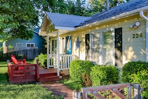 A house with a porch, a number 224 on the side, and a red chair outside. - Star lodge near the center (Star)