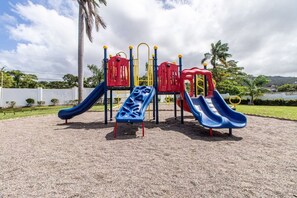 A playground with multiple slides and climbing structures.