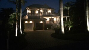 A two-story house with a balcony, surrounded by palm trees. - 8M Dollar Home, 3 Houses from Beach in Old Naples! (Naples)