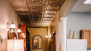 A hallway with wooden flooring, a decorative ceiling, a white refrigerator, and a lamp. - Crossroads Flat:  Steps away from Rt. 66 & Carthage square (Carthage)