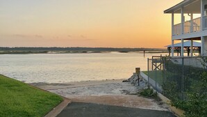 A beachfront property with a paved driveway leading to a covered porch overlooking the sea. - Beach & Boating & Fishing Paradise! With 2 Kayaks Included!!! (St. Augustine)