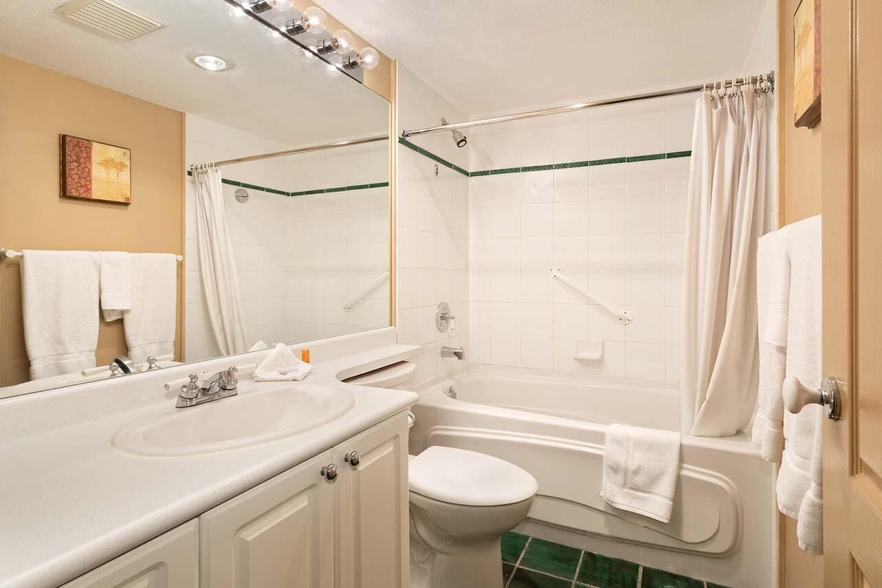 A bathroom with a sink, toilet, and bathtub.