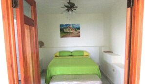 A small, narrow room with a single bed, a ceiling fan, and a picture on the wall. - Panoramic views with room to roam in a relaxing environment. (Haughton Court)