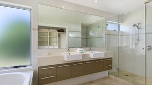 Bathtub, hair dryer, towels, toilet paper