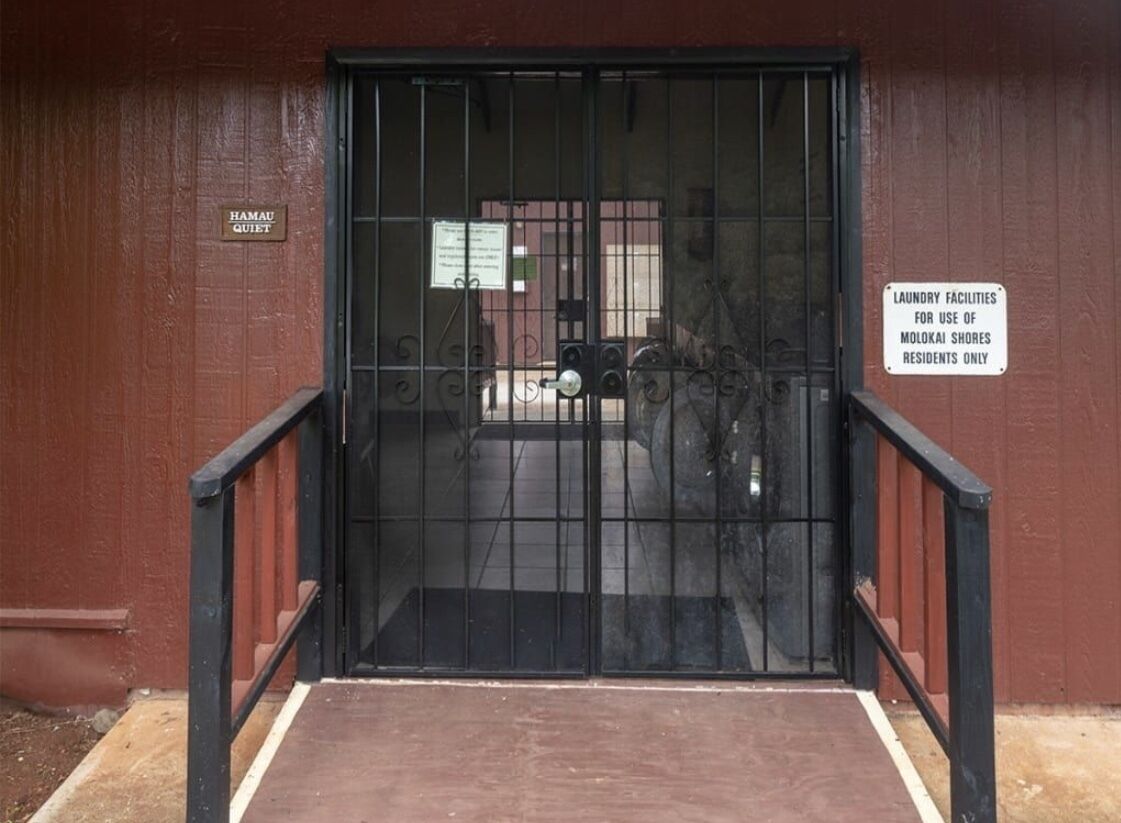 A gated entrance with a sign indicating it is for the use of Molokai Shores residents only.