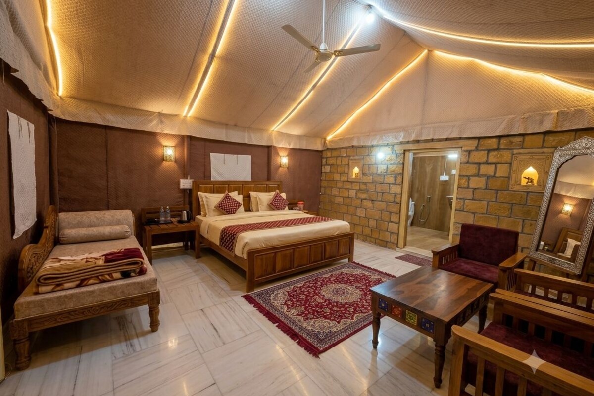 Une pièce spacieuse avec un grand lit, un canapé en bois, une petite table et un mur en pierre.