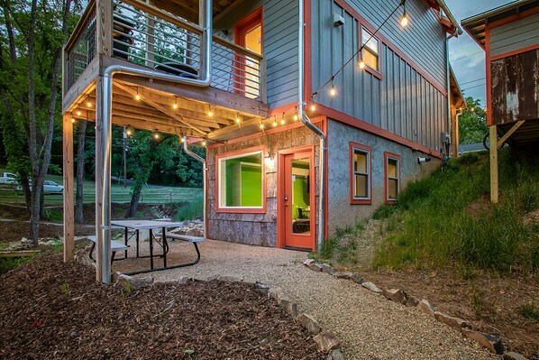 Enjoy outdoor dining or relaxation on the covered patio with a picnic table and seating area.