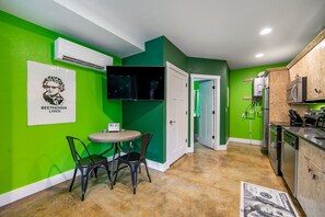 Enjoy casual dining and socializing in this compact kitchen area with microwave and oven, air conditioning, and a unique cultural touch.
