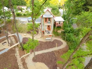 Set amidst lush greenery, this unique structure offers a serene escape with a sloped roof and entrance.