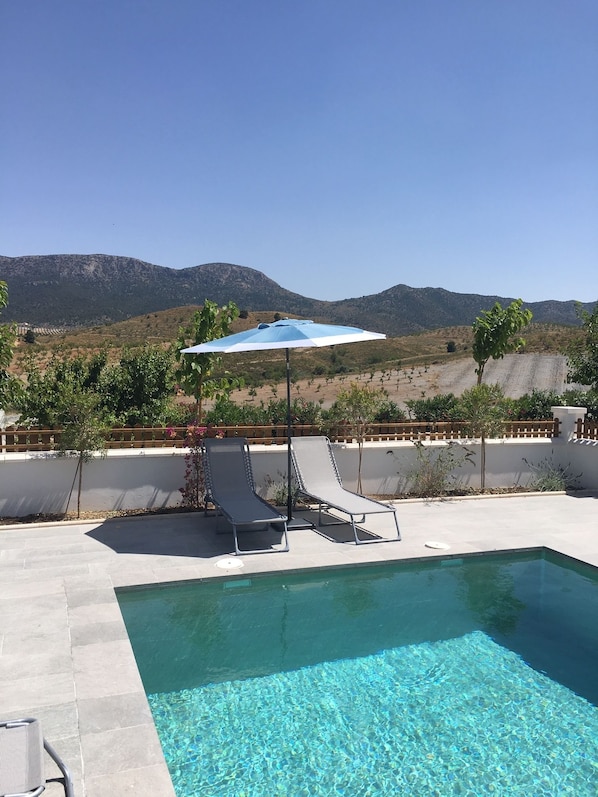 Seasonal outdoor pool, open 10:00 AM to 7:00 PM, pool umbrellas