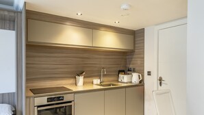 A modern kitchen with built-in appliances, a sink, and a countertop. - Cocoa Suites 49 - York city centre studio (sleeps 2) (York)