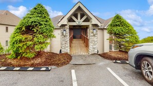 A building with a stone facade, a wooden door, and the number 35 on the front. - Close-to-slopes condo w/gourmet kitchen & stone fireplace (Sugar Mountain)