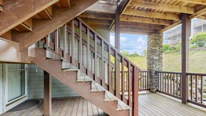 A wooden staircase with a stone pillar on a wooden deck. - Close-to-slopes condo w/gourmet kitchen & stone fireplace (Sugar Mountain)