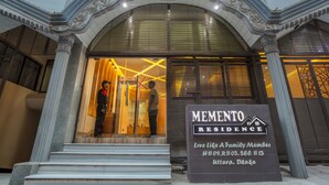 A building entrance with a sign for 'MEMENTO RESIDENCE' and a staircase leading up to the entrance. - Memento International (Dhaka)