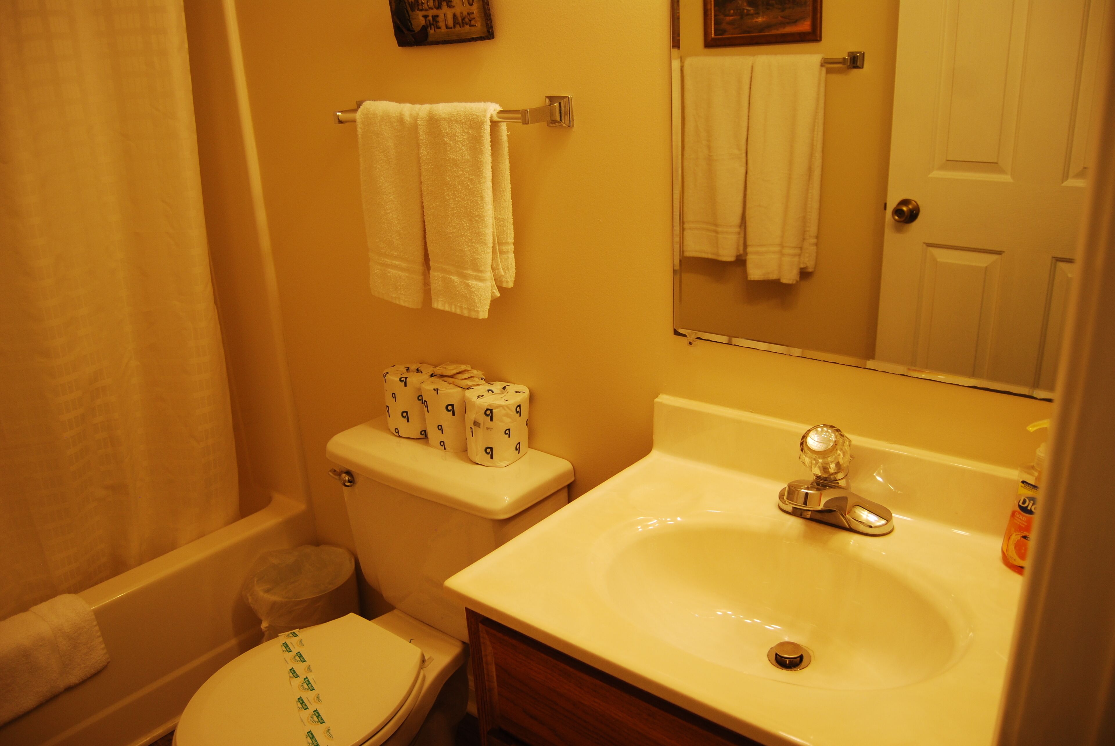A bathroom with a toilet, a sink, and a bathtub.