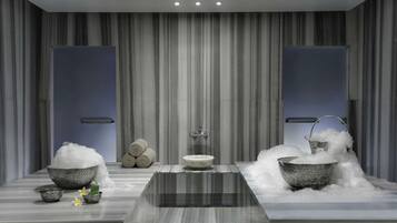 Experience a spa-like atmosphere in this serene bathroom with a central mirror, dual sinks, and a potted plant.