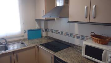 Fridge, microwave, coffee/tea maker, cookware/dishes/utensils