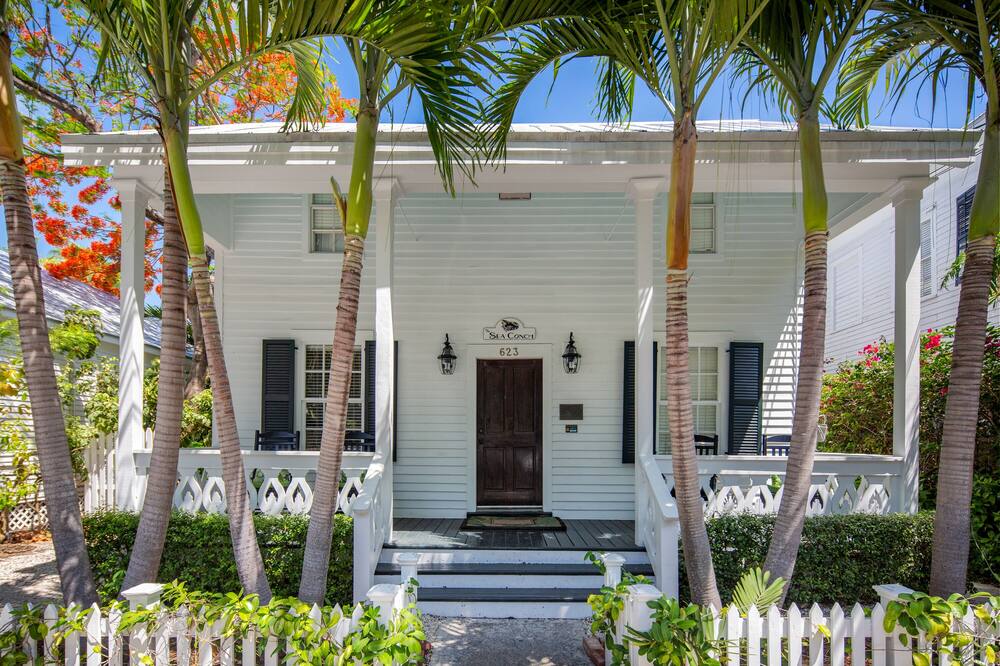 THE PROPERTY: Queen Conch is a Key West hidden gem located in perhaps the best location you could ask for. Nestled in the heart of Old Town Key West - just 2 short blocks from Duval Street - you are within walking distance to anything and everything you will want to experience during your tropical vacation. <br><br>Queen Conch is the perfect home with tropical pool for large groups and includes three separate vacation rentals - "Sea Conch," "Rooster Conch," and "Horse Conch."<br><br>The downstairs, two bedroom unit - "Sea Conch" - offers an open and spacious floor plan throughout the living and dining area. Beautiful French doors open up to the covered porch and the lush, tropically landscaped garden and pool area. <br><br>Upstairs lies two separate one-bedroom suites - "Rooster Conch" and "Horse Conch" - which can be accessed from the shaded balcony that overlooks the pool below, providing a cool spot on a hot afternoon. Each suite is decorated with its own splashes of tropical color and comfy queen beds. <br><br>Each of the three units have their own fully equipped kitchens, quiet AC systems, and pull out sleeper sofas, making this the perfect home for group getaways such as family reunions, birthday celebrations, or bachelor and bachelorette parties! <br><br>BED CONFIGURATION: Each of the two downstairs bedrooms includes a comfy queen bed, and ensuite bathrooms with large walk in showers and cute Key West decor. The two individual upstairs units also have an amazing queen bed. Each unit has a queen sleeper sofa as well. Please note there is NO TV in the bedroom of the Horse Conch.<br><br>The shared washer/dryer is located in a shed on the left side of the home near the pool.<br><br>OUTDOOR AMENITIES: The complex boasts a breathtaking tropical outdoor area with a pool that is shared by guests. The pool is heated seasonally (November through April) for an additional fee which will be assessed at the time of booking.<br><br>PARKING: Off-street parking for one vehicle, which is great since parking in Key West is limited.<br><br>LOCATION: A majority of the tourist attractions are located here as well as numerous restaurants, shops and galleries. The neighborhood boasts historic homes, shotgun and conch style homes. <br><br>NEARBY: Grab morning coffee down the street from local favorites such at Cuban Coffee Queen, Starbucks, and 5 Brothers Coffee or go for lunch and drinks at world famous restaurants and bars like Caroline\'s, Fogarty\'s, Blue Heaven, Irish Kevin\'s and Sloppy Joe\'s - all within a 10 minute walk!<br><br>PETS: This home is NOT pet friendly. (If you have pets, please browse through our many homes that are pet-friendly).<br><br>SMOKING: This is a non-smoking home and property. <br><br>So hurry up and come out of your "shell" - rent "Queen Conch" today!<br><br>***Guests must be 25 years of age or older unless accompanied by an adult.<br><br>***Managed by Historic Key West Vacation Rentals*** QUEEN CONCH ~ Stunning