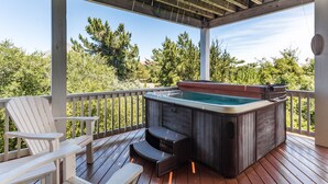 A wooden deck with a hot tub, white Adirondack chairs, and a pergola. - Love R Shack: Oceanside Duplex, Spa, Shared Pool (Corolla)