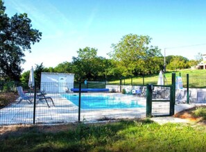 A fenced backyard with a swimming pool, lounge chairs, and a small shed. - GITE LILAS (Notre-Dame-de-Sanilhac)