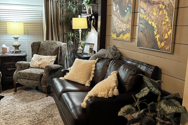 Sitting area with leather love seat, recliner, chair and foot stool