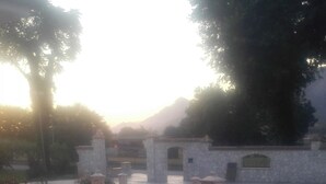 A paved courtyard with stone planters and a stone wall. - Agriturismo Antica Casa Scardone (Piedimonte San Germano)
