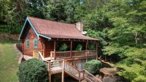 A log cabin with a porch, a staircase, and a satellite dish. - Southern Charm #88 -Charming & Clean Log Cabin! (Sevierville)