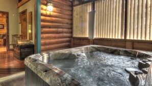 A hot tub in a log cabin with wooden walls and a wooden floor. - Southern Charm #88 -Charming & Clean Log Cabin! (Sevierville)